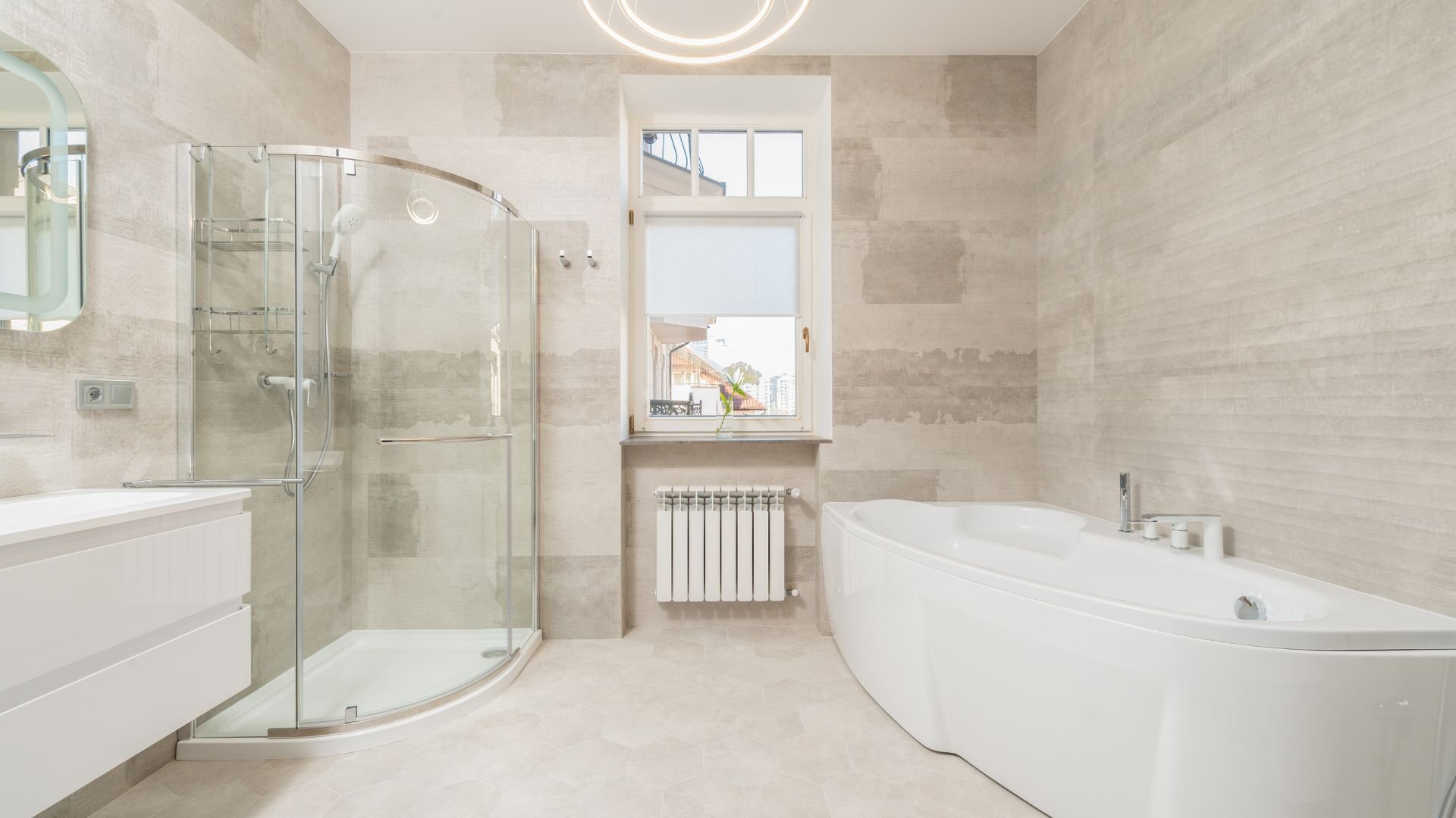 Modern, bright bathroom with glass shower, white bathtub, and window